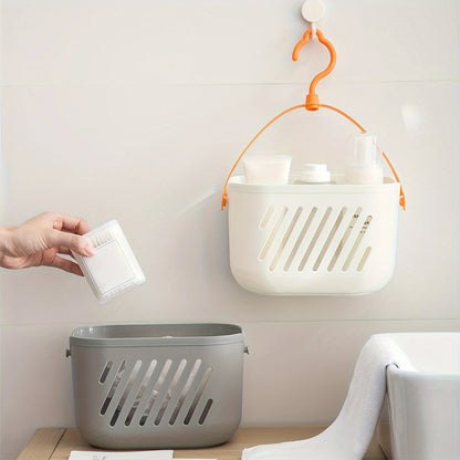 White and grey hanging storage baskets with orange hook mounted on wall for pantry and bathroom organization