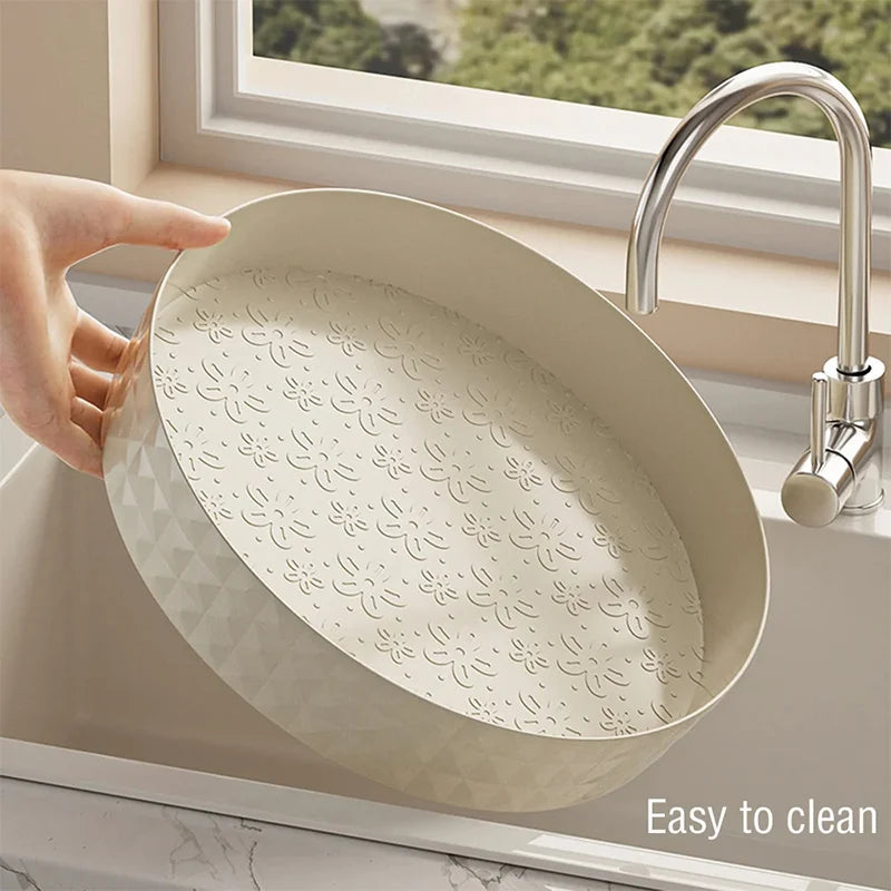 Cream lazy susan kitchen organizer being washed at sink showing easy to clean waterproof design