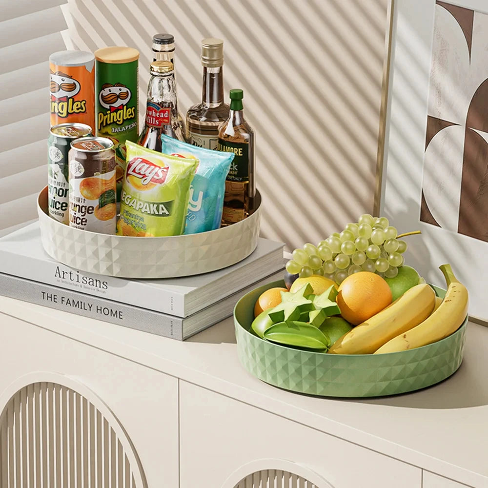 Two lazy susan organizers on counter: white with snacks and drinks, green matcha with fresh fruit display