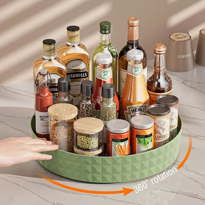 Green lazy susan spice rack being rotated 360-degrees showing pantry and condiment organizer in action on marble countertop